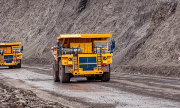 Yellow mining trucks on a road